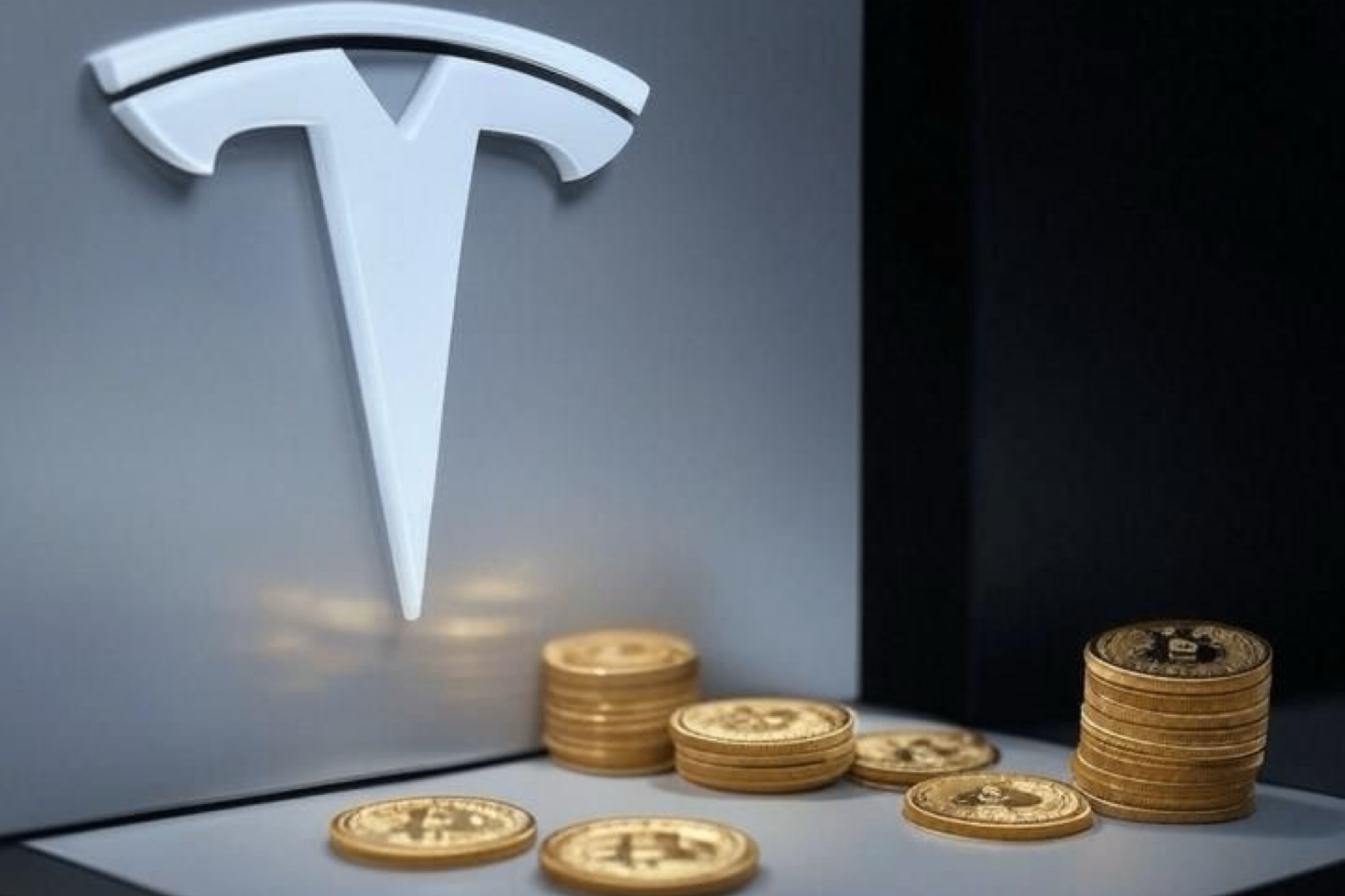 Tesla logo above stacks of Bitcoin coins